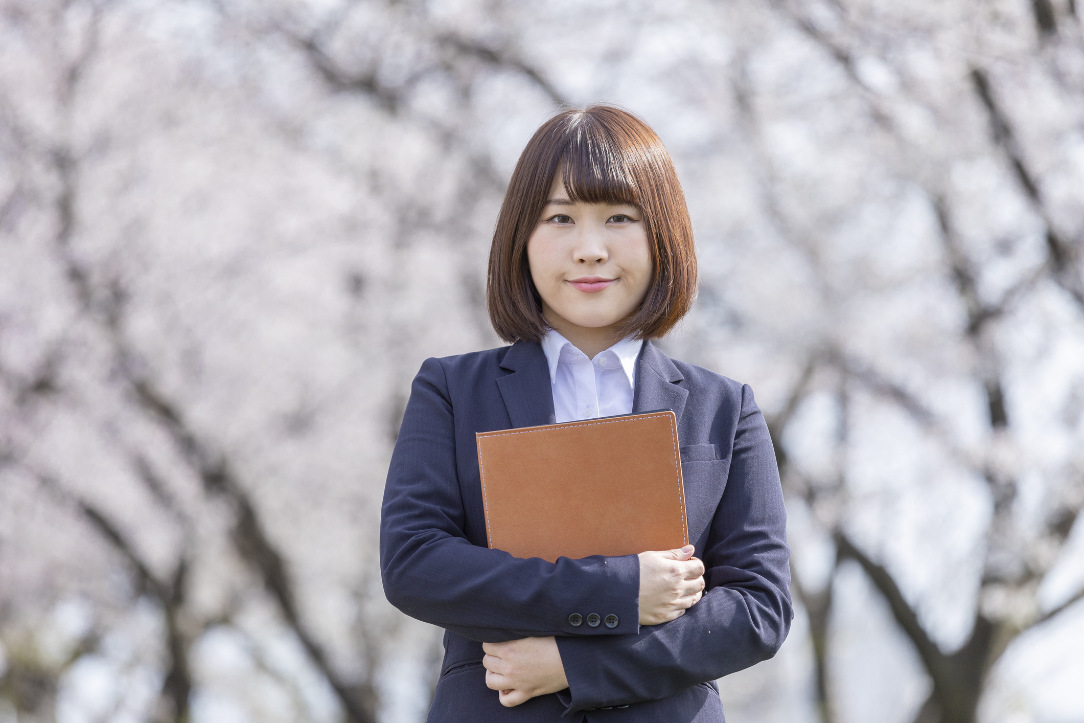 Woman in suit and cherry blossom